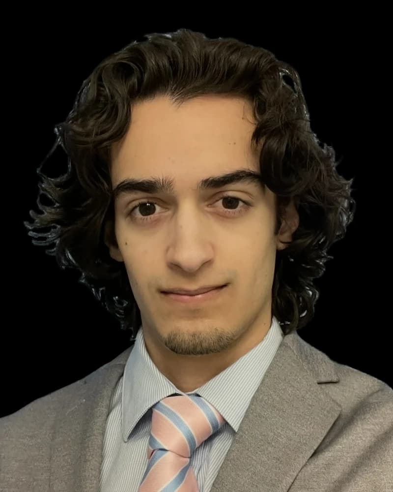 Jancarlos Sosa wearing a gray suit and striped tie